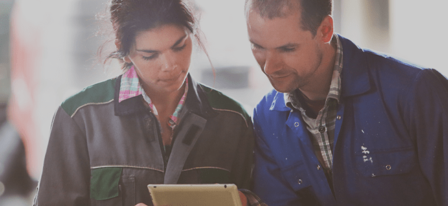 A man and a woman looking at an electronics screen