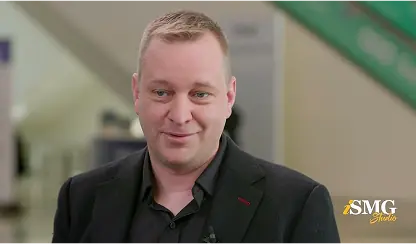 Business professional at a cybersecurity conference, representing how AI is transforming ransomware defense and cyber risk management